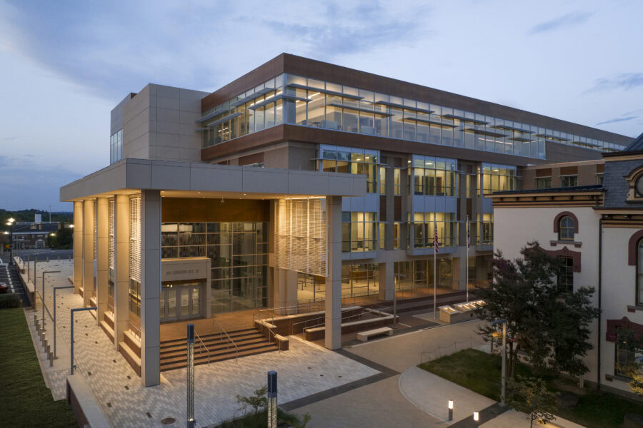 The exterior of a building with a large glass wall.