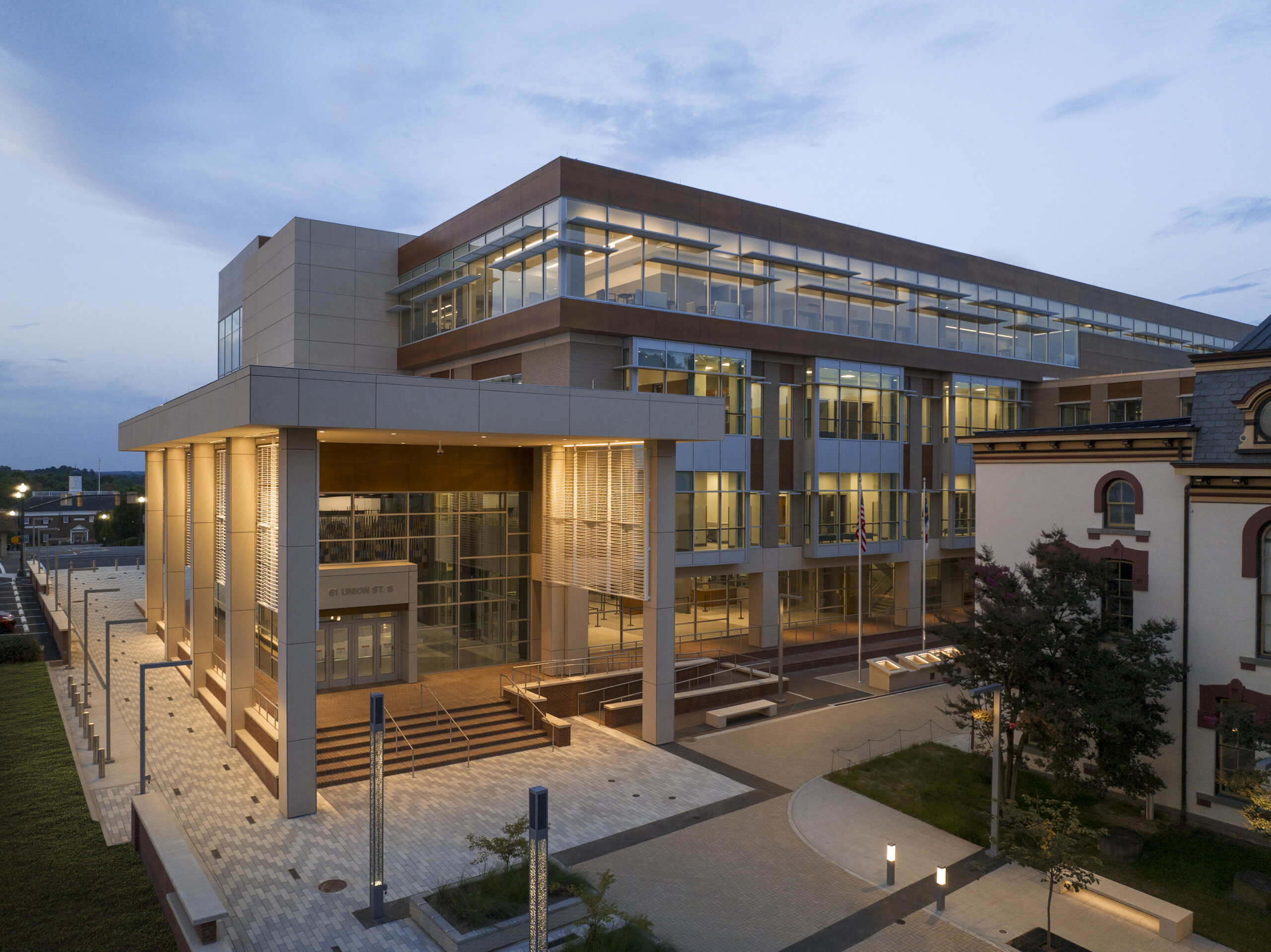 The exterior of a building with a large glass wall.