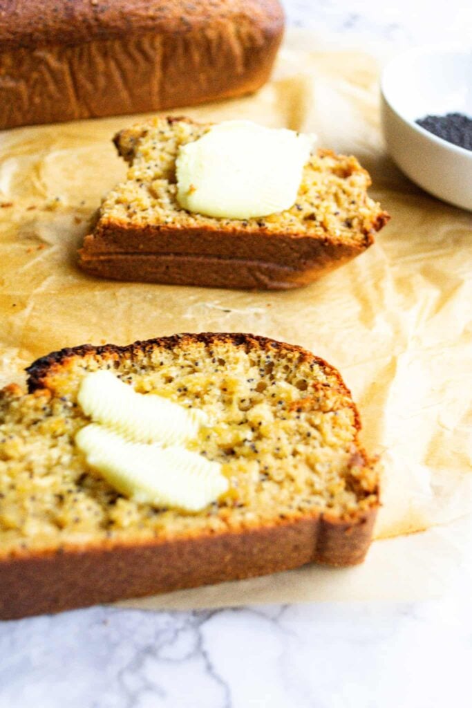 Two slices of orange poppyseed loaf with butter