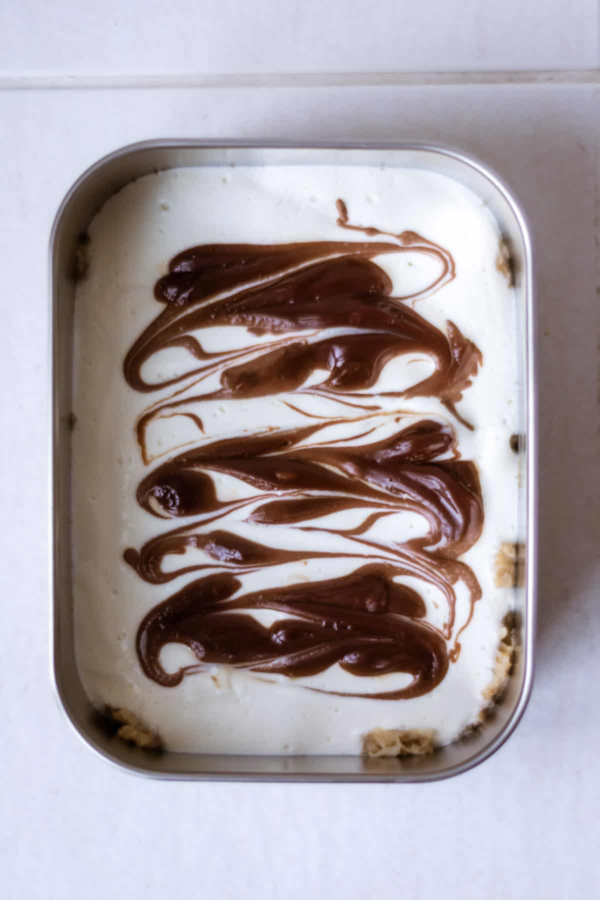 Flat lay shot of nutella overnight weetabix in a meal prep container.