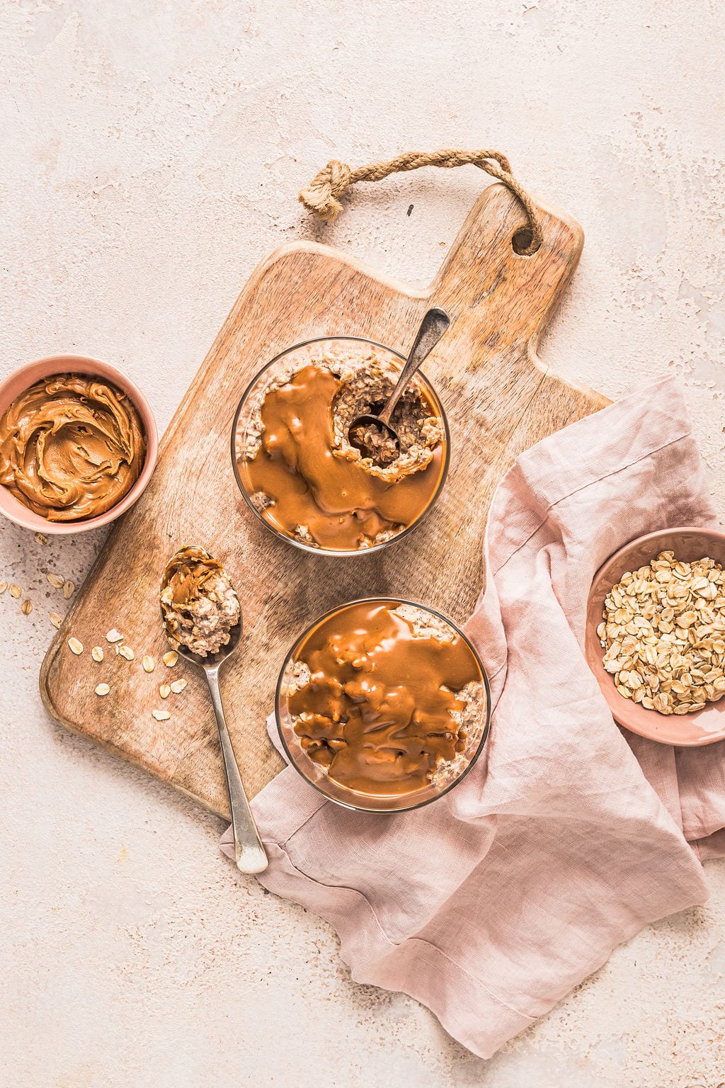 Overhead shot of two bowls of Biscoff overnight oats with melty Biscoff on top.