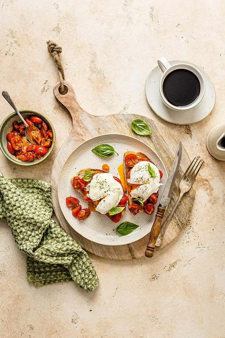 Overhead shot of breakfast bruschetta on a plate with poached eggs.