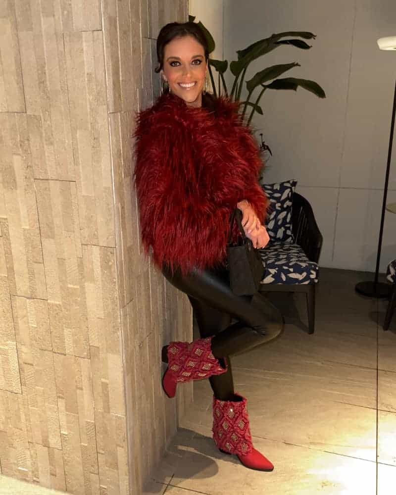Skylar Porter with SkyStruk cabernet red boots and red fur coat