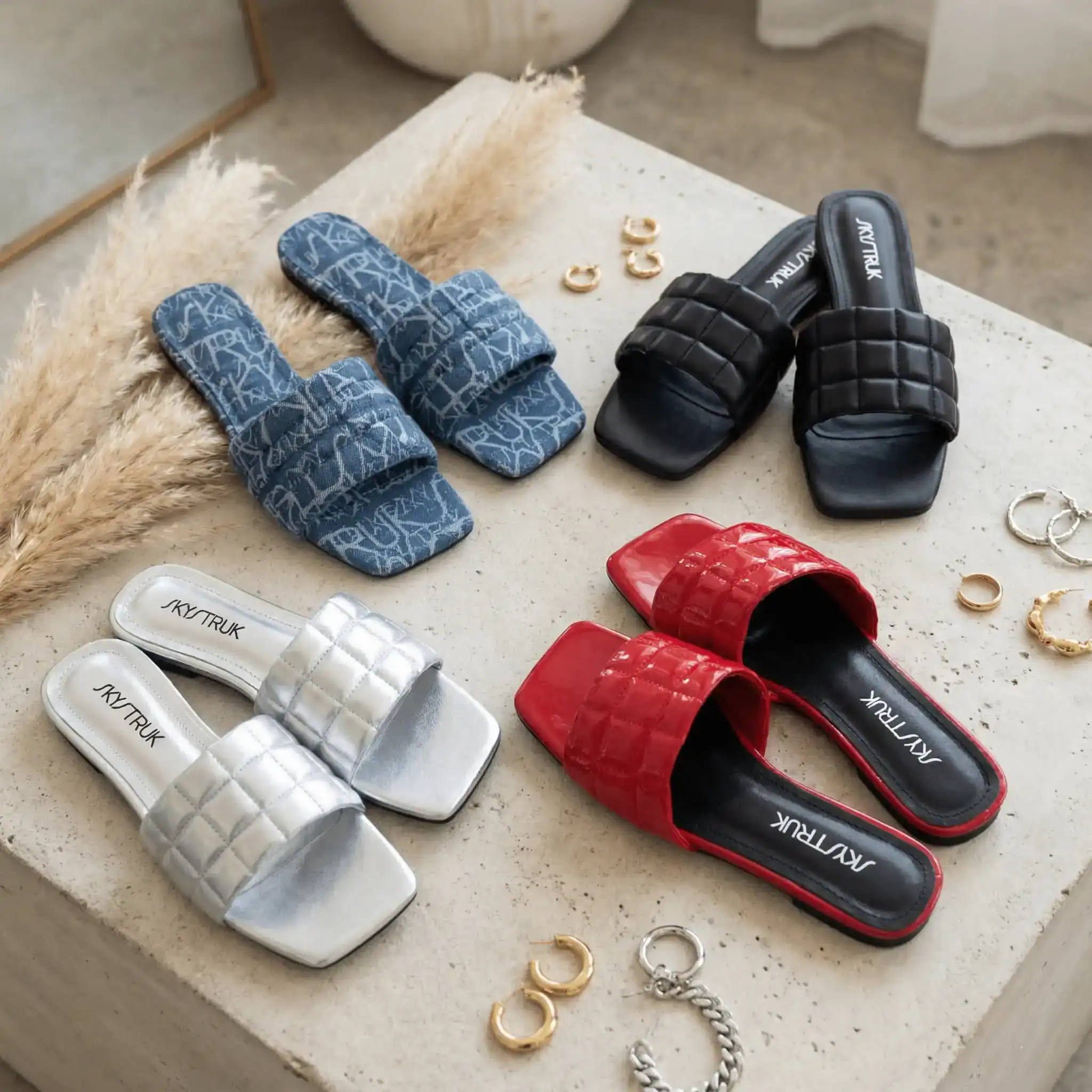 4 pairs of the Skylar Flat on a table with jewelry