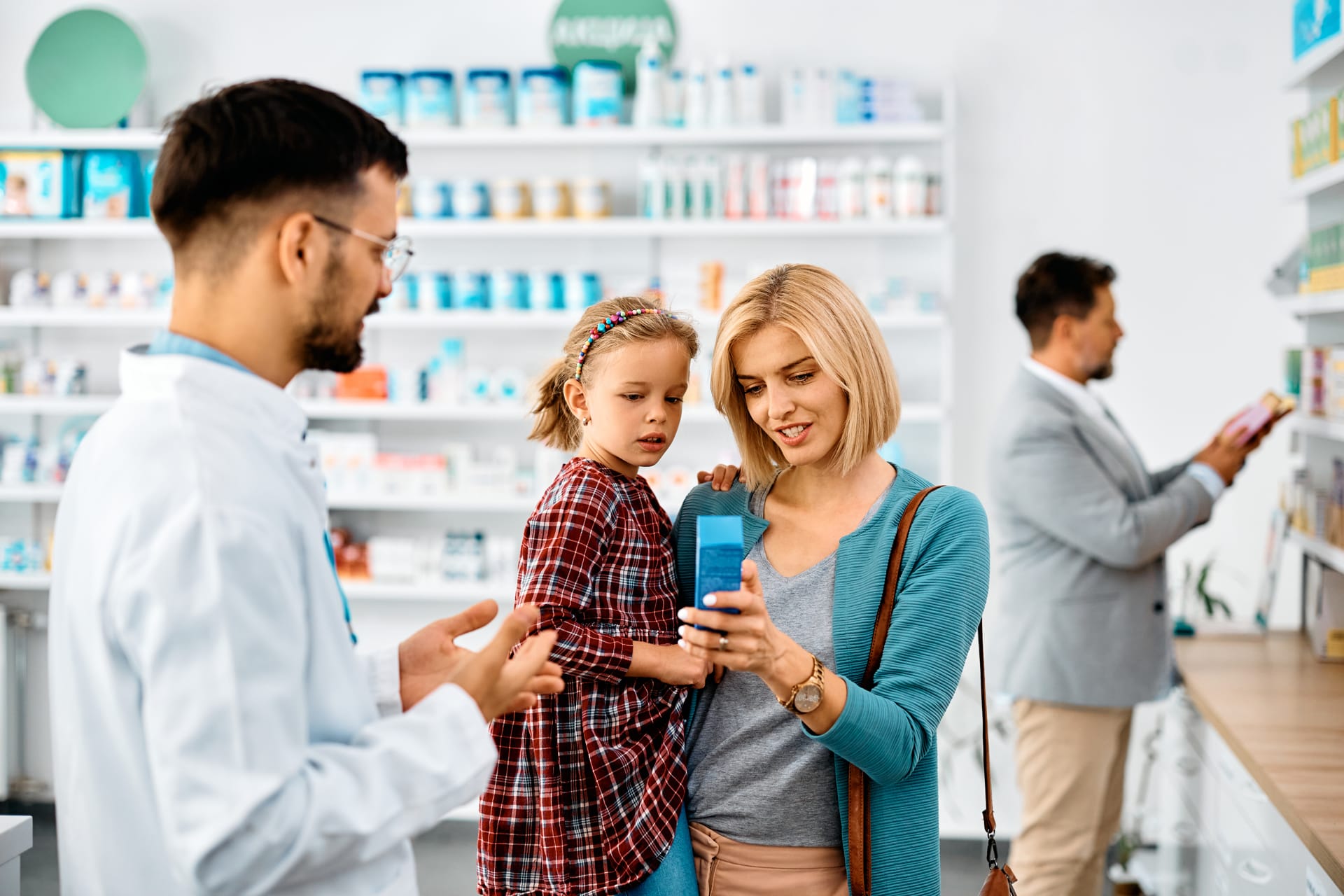 Mother getting help at pharmacy