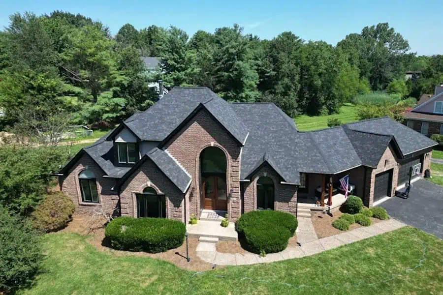 Luxury brick home with new roofing installation.