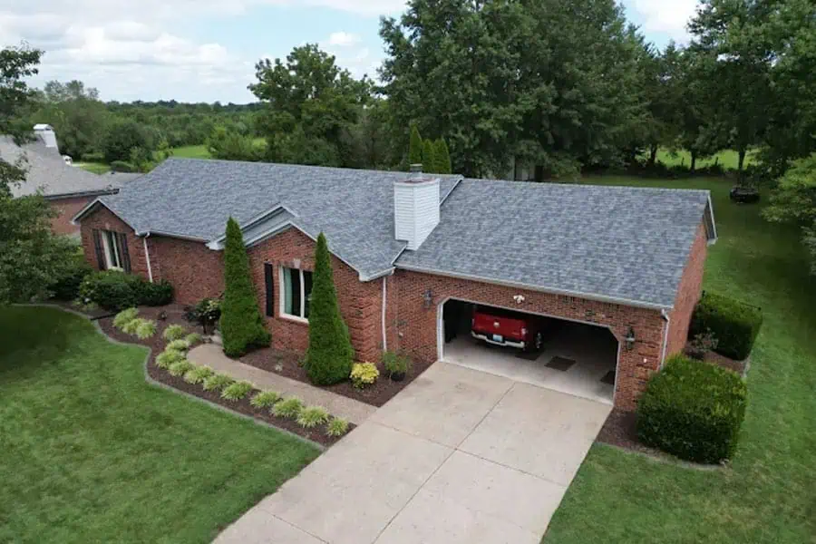 Modern brick home with new roofing and landscaped yard.