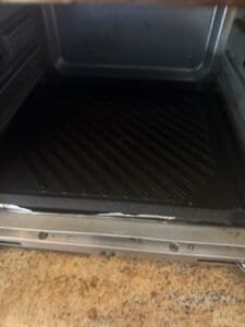 an electric griddle plate in combo cooker