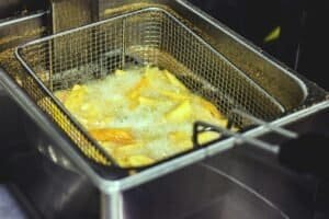 a deep fryer cooking fries minimal in home