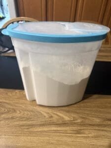 a food storage container with flour on counter