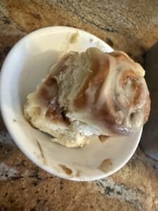 a cinnamon roll on countertop in kitchen