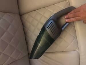 handheld vacuum sitting on couch