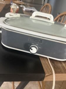 a slow cooker on countertop in kitchen