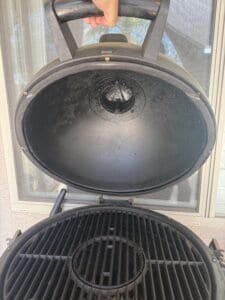 a dusty kamado grill in desert ready for clean