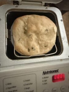a bread machine pan with a loaf inside