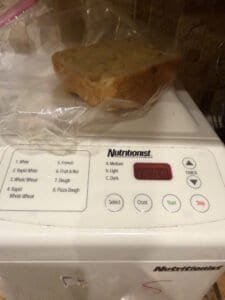 a partial bread loaf sitting on a bread machine