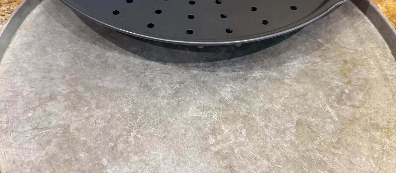 Best Pizza Pans and Crisper Trays in 2026: Perforated, Solid, and Stone Picks