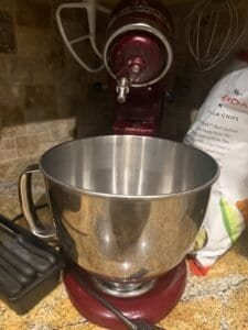 a stand mixer with a mixing bowl on kitchen counter