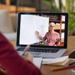 Blended Learningprofessor doing math on video call. Latin girl student studying from home and watching teacher explaining math formula on video chat.
