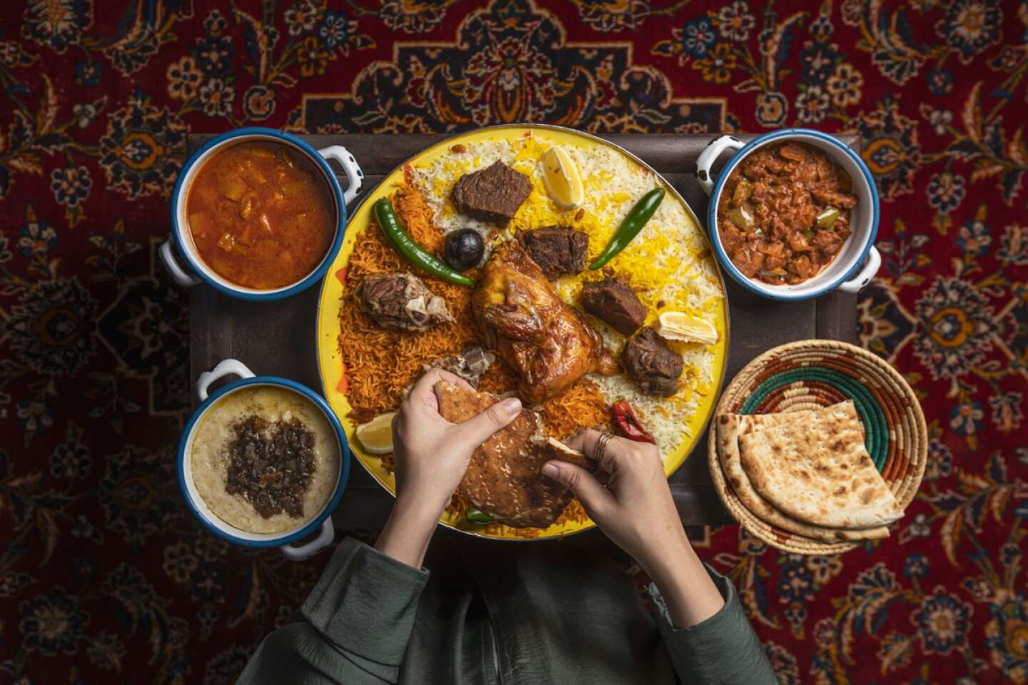A person enjoying traditional Saudi food - (Credits Visit Saudi)