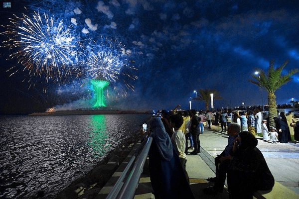 People sitting by the shore to watch fireworks (credits saudi gazette)