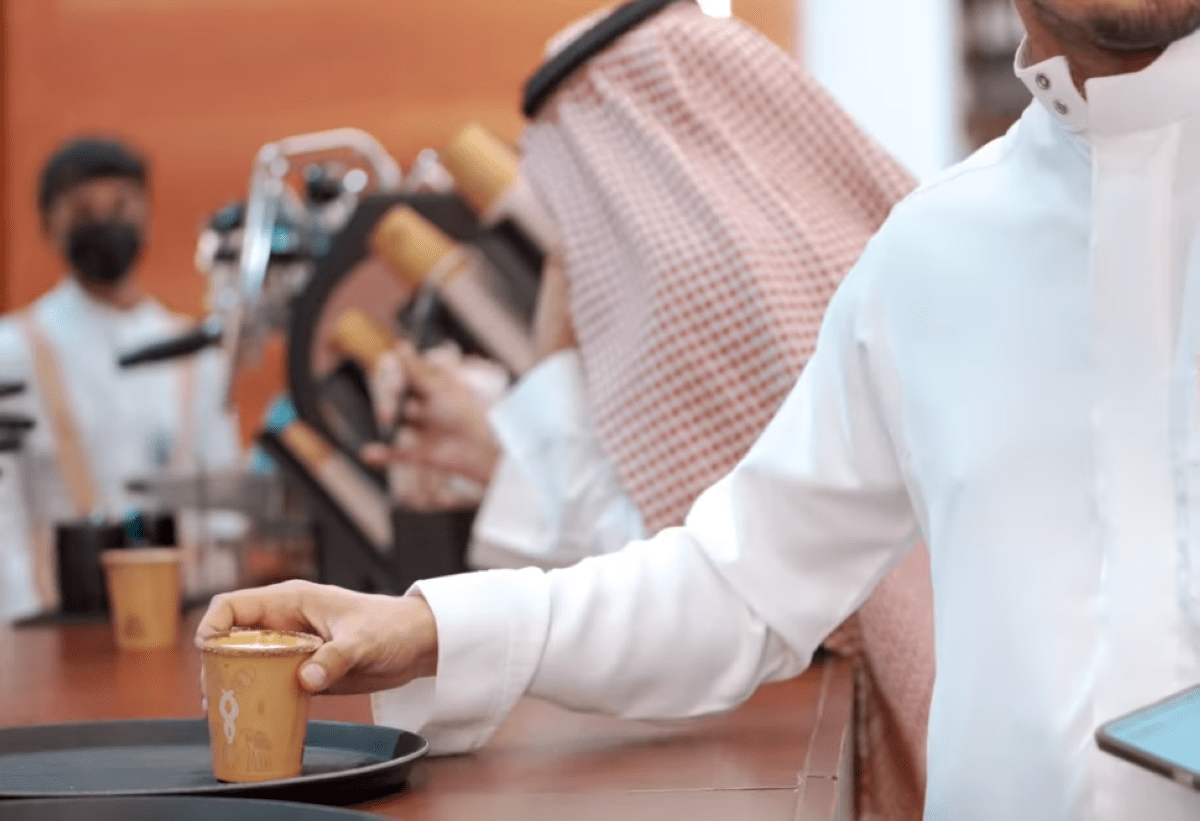 A person holding a cup of camel milk in a specialty cafe in Riyadh, Saudi Arabia - (Credits List Magazine)