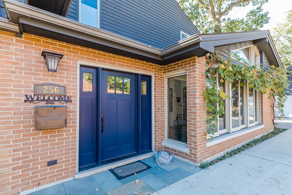 Home exterior remodel with brick siding and blue front door
