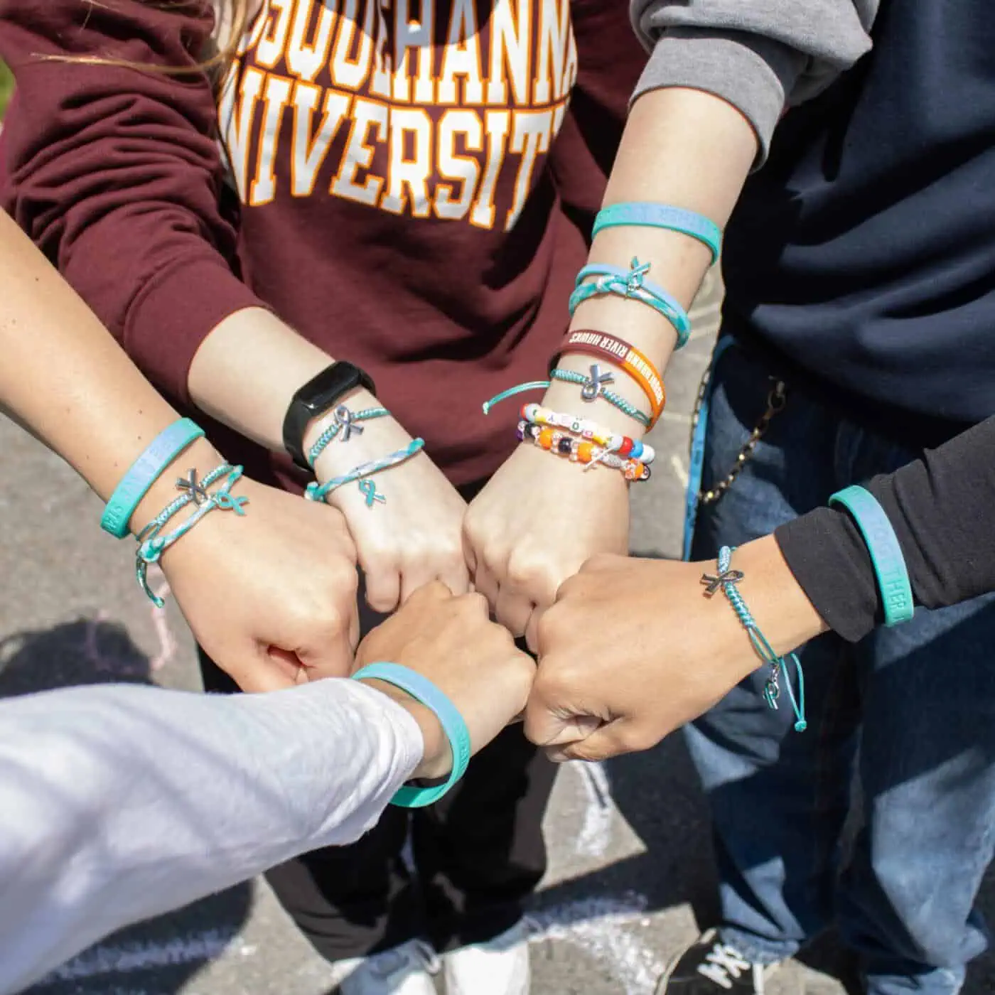 Group of students with bracelets showing unity for drug policy reform.