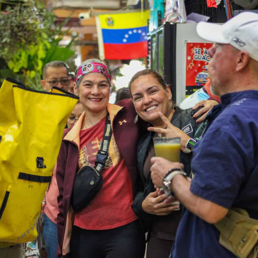 Travelers at a street food drinking fresh juice at a traditional Market