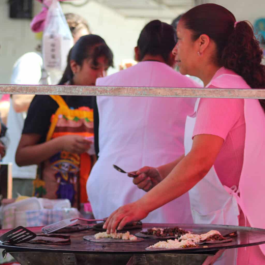 Vendor making handmade tortillas during a Food Hood Tours food stop.