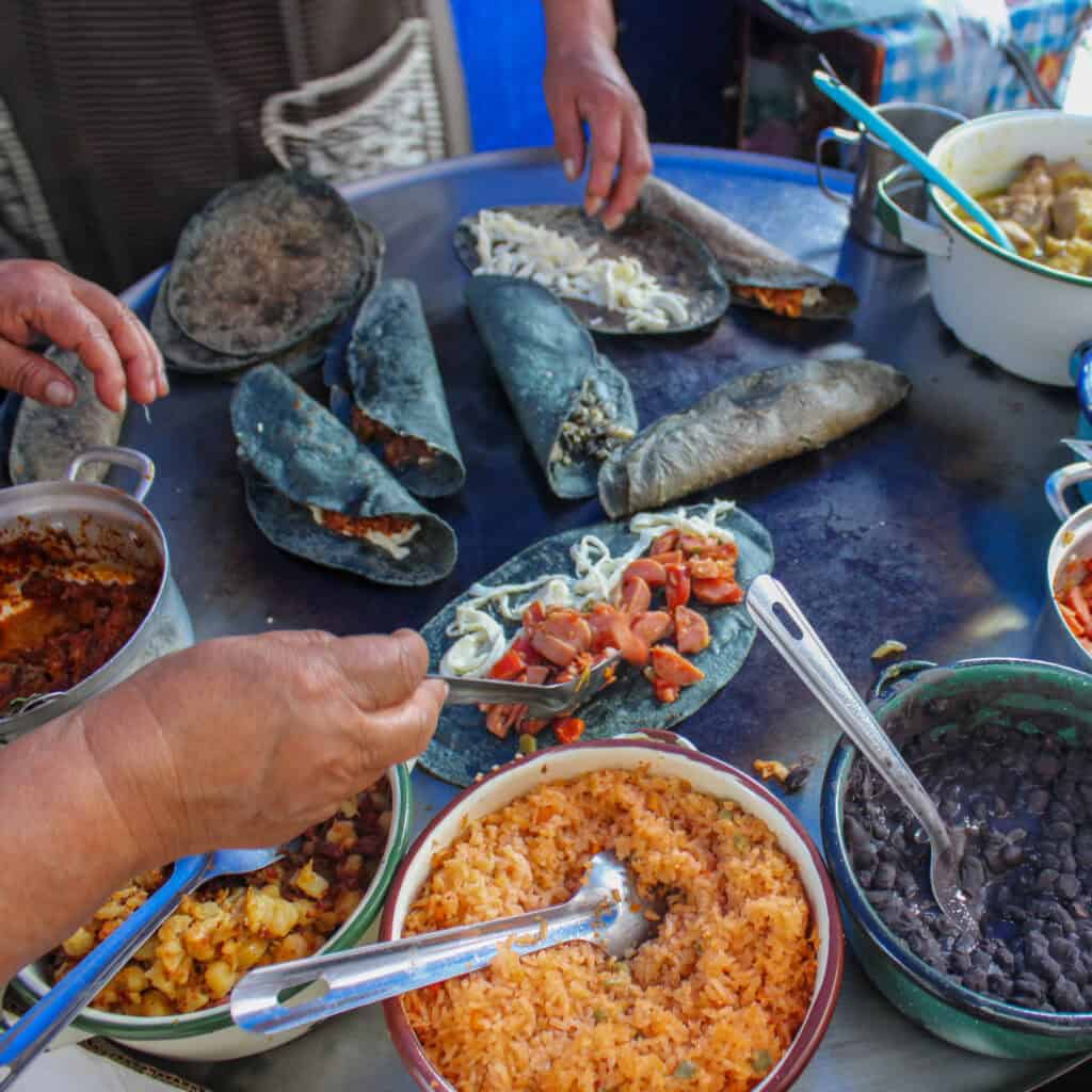 Street food vendor preparing fresh tacos in Mexico City.