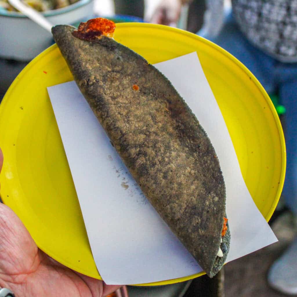 Close-up of a quesadilla being carved at a Food Hood Mexico food stop.