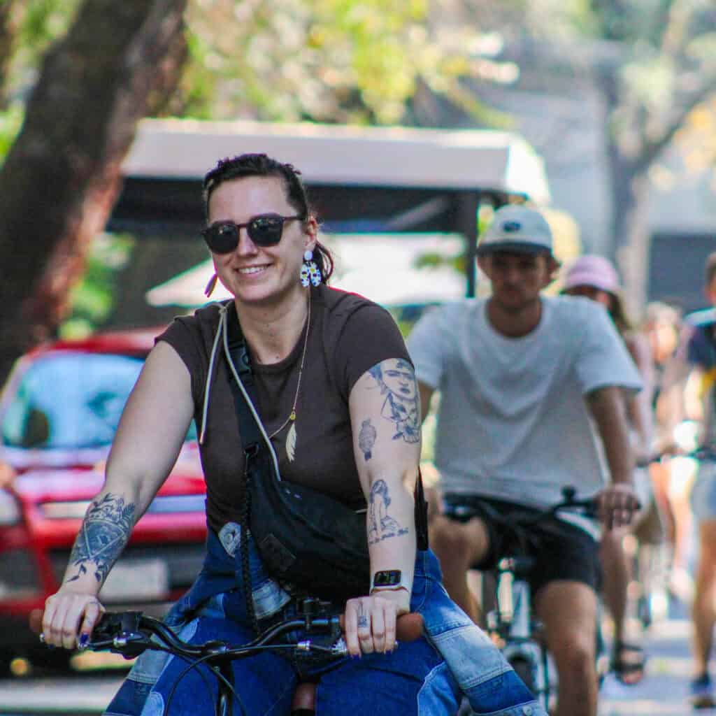 Food Hood Tours cyclists riding into Chapultepec Park surrounded by trees.