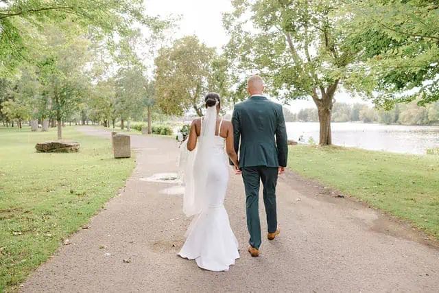 Couple walking through Riverside Park before their elopement ceremony
