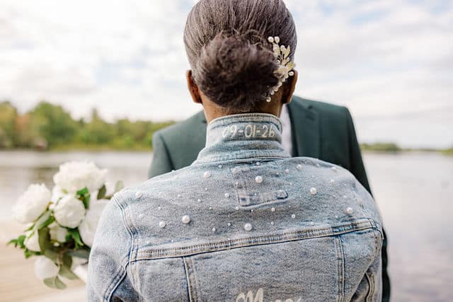 Bride and groom portrait by the water at Riverside Park