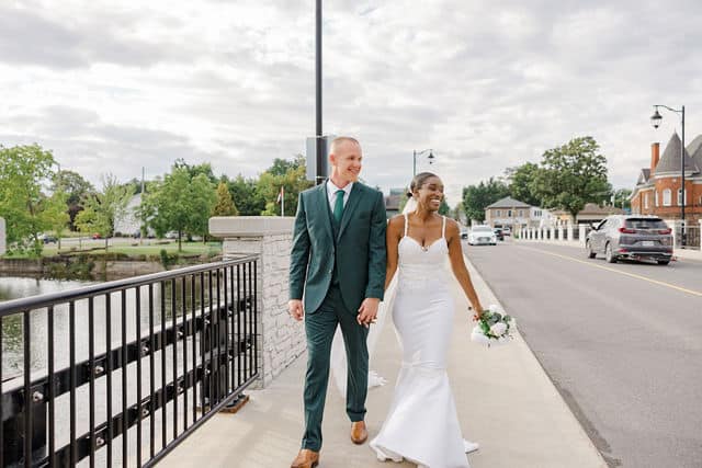Bride and groom walking through Carleton Place after their ceremony