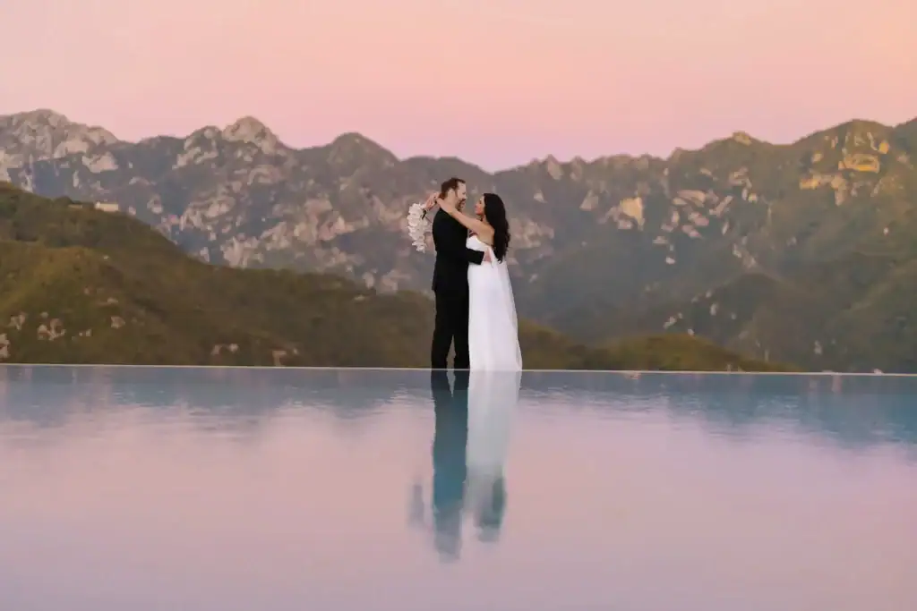 a warm embrace standing on the infinity pool of the belmond Caruso hotel.