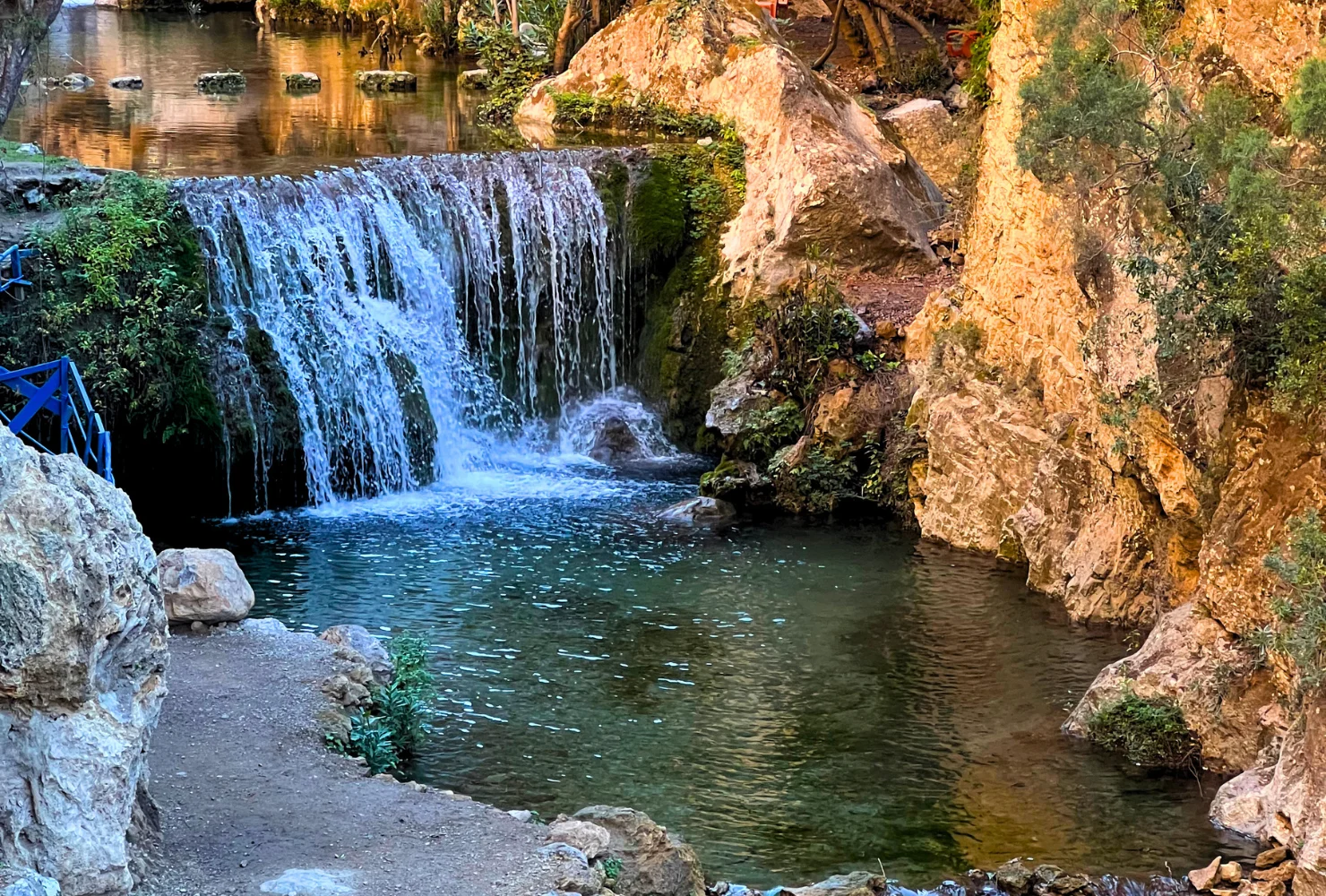 Panoramic view of a waterfall in mountain foothills on an Akchour day trip from Tangier