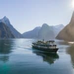Milford Sound cruise with Mitre Peak and waterfalls in the background.
