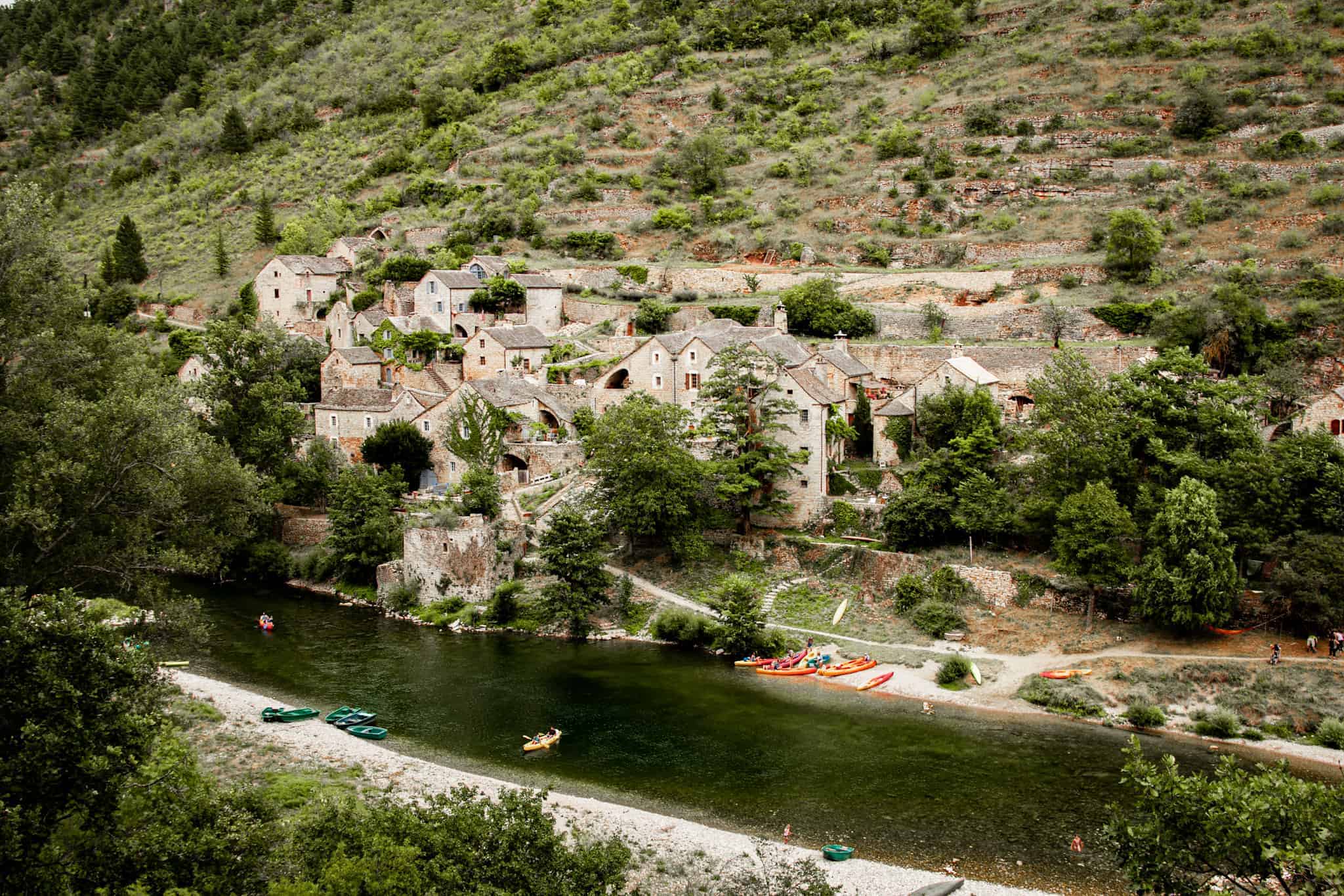 kayaks along the Gorges du Tarn, in front of a small village