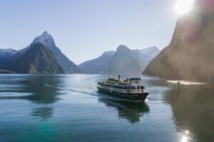 Milford Sound cruise with Mitre Peak and waterfalls in the background.