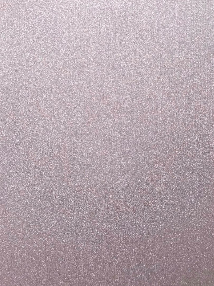 Close up of a pink metallic glittery surface with fine sparkles