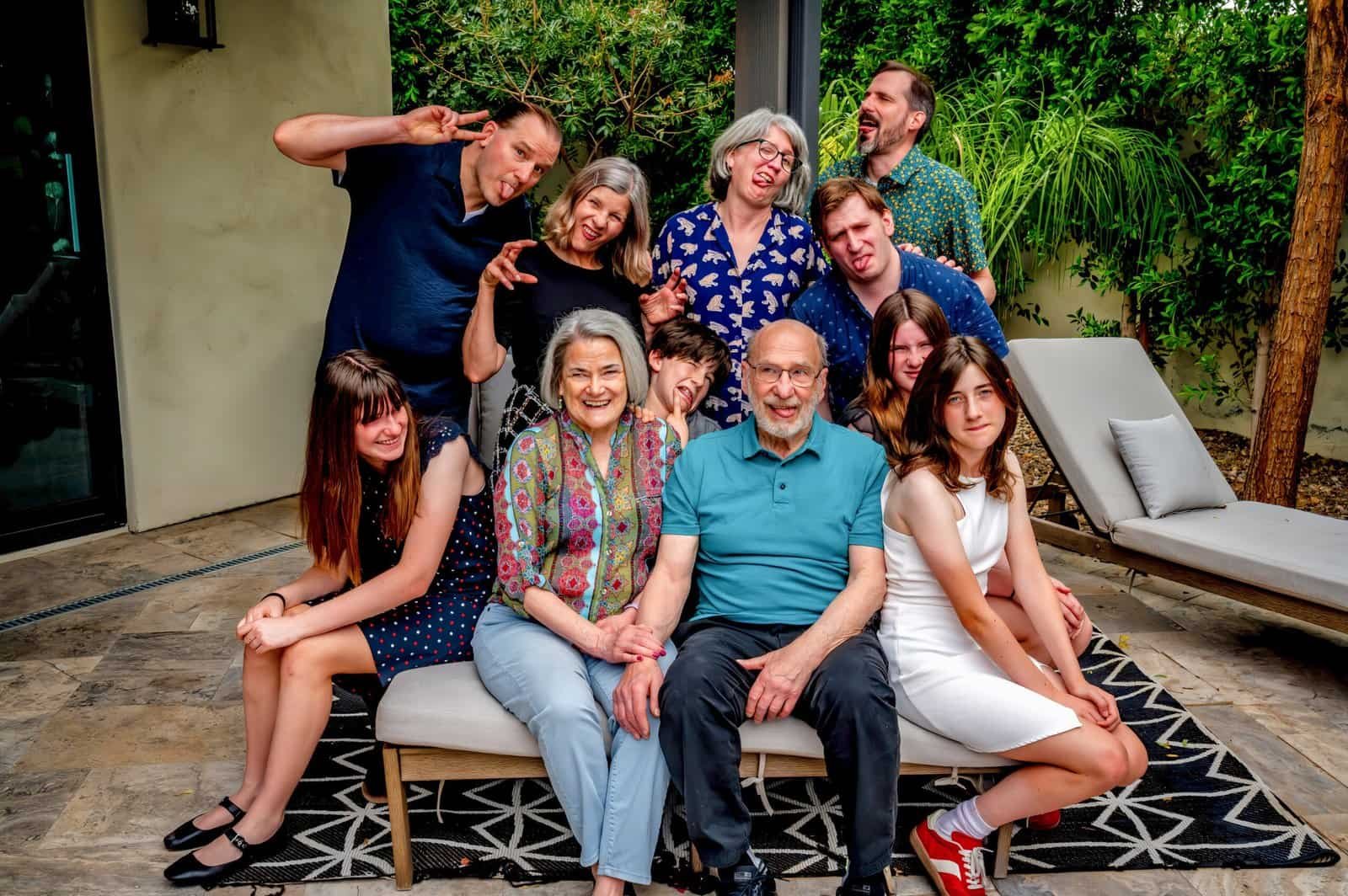 A joyful family group enjoying a special moment outdoors in their backyard, capturing happiness and togetherness.