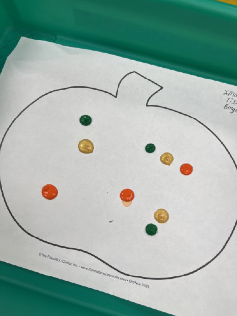 Photo of pumpkin with paint drops on it. This is an Easy progressive art idea.