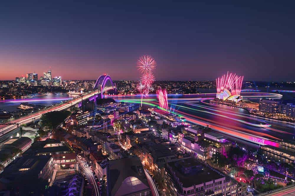 the lights of Vivid Sydney illuminating the harbour and city