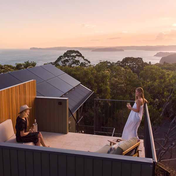 2 women on a balcony in the Central Coast with views in the background