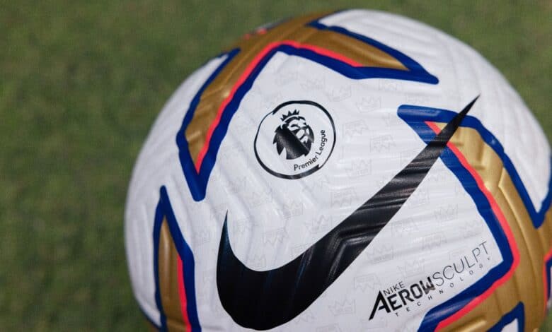 Close-up of an official Premier League football featuring Nike AeroSculpt technology, on a grass pitch, emphasizing football equipment and Premier League branding.