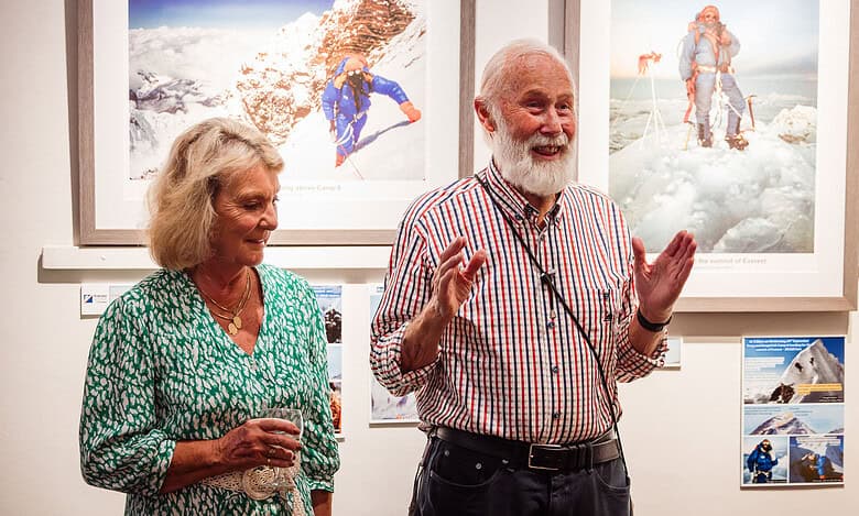 Photographers at an outdoor exhibition showcasing mountain climbing and snow expedition photography.