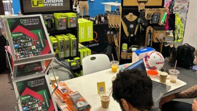 Sports betting and sports merchandise display at an indoor sports shop or event, showcasing various sports equipment, apparel, and promotional materials.