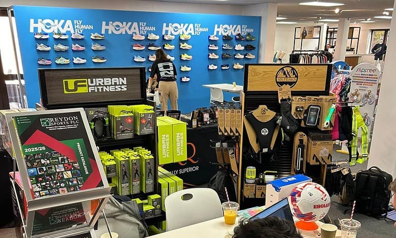 Sports betting and sports merchandise display at an indoor sports shop or event, showcasing various sports equipment, apparel, and promotional materials.